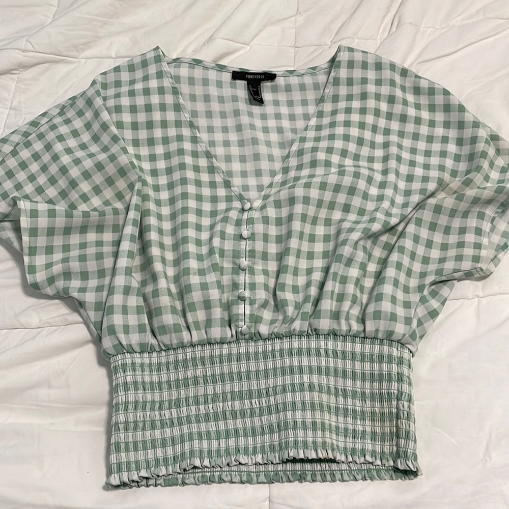 A cute green and white plaid dress shirt!Would go perfect with high wasted jeans